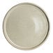 A round, beige porcelain stack plate with a subtle speckled finish.
