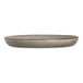 A round, shallow, gray porcelain plate with a slightly raised rim.