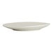 A round, white porcelain coupe plate with a slightly irregular, shell-inspired shape.