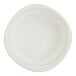 A small, round, white porcelain ramekin with a subtle speckled pattern.