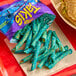 A bag of Takis Blue Heat rolled tortilla chips spilled onto a napkin.