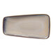 A beige asymmetric rectangular porcelain coupe platter.