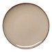 A round beige porcelain coupe flat plate with a slightly slanted edge.