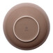 A large beige round porcelain bowl shown upside down.
