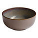 A beige round porcelain coupe bowl with a textured interior.