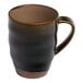 A blue porcelain mug with a rustic, handcrafted appearance and a sturdy handle.