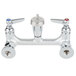 A T&S chrome wall mount mop sink faucet with silver knobs.