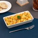 A rectangular ivory porcelain deep platter filled with macaroni and cheese.