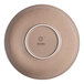 A beige round porcelain coupe deep plate shown from the bottom with the Ariane logo.