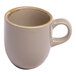 A small beige porcelain espresso cup with a handle.