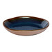 A round blue porcelain coupe bowl with a glossy finish.