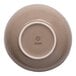 A beige round slanted porcelain coupe bowl shown upside down.