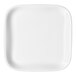 A small, square, ivory porcelain plate with rounded edges.