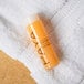 A small bottle of PAYA papaya conditioner placed on a white towel.