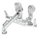 A T&S rough chrome wall mount service sink faucet with two silver knobs.