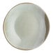A round, light-colored stoneware bowl with a slightly irregular rim and a subtle gradient glaze.