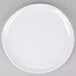 A white, irregular round melamine coupe plate with a subtle decorative edge.