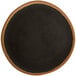 A round brown coupe plate with a dark glazed center and a clay trim.
