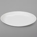 A plain, round, ivory-colored melamine dinner plate.