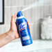 A can of Lysol White Linen Scent Air Sanitizer Spray being used in a bathroom setting.