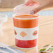 A 32 oz. double poly-coated paper soup or hot food cup with a vented plastic lid.