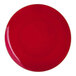 A round red plastic plate with a gold band around the edge.