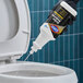 A bottle of CloroxPro Clorox urine stain and odor remover being poured into a toilet.