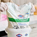 A refill pack of Clorox Healthcare hydrogen peroxide cleaner disinfectant wipes being placed into a container.