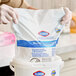 A package of Clorox Healthcare bleach germicidal wipes refill being placed into a container.