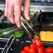 A person using Sabert silver plastic serving tongs to serve food at a salad bar.