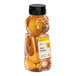 A 12-ounce bear-shaped squeeze bottle filled with all-natural amber honey.