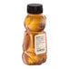 A 12 oz. bear-shaped squeeze bottle filled with all-natural amber honey.