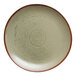 A round, sage green porcelain plate with a subtle speckled pattern and a brown rim.