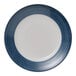 A round white porcelain plate with a wide blue band around the rim.