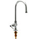 A T&S chrome deck-mount faucet with a yellow spout.