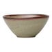 A sage green porcelain bowl with a subtle textured pattern and a reddish-brown rim.