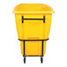 A large yellow heavy-duty bulk tilt truck with a black metal frame and four caster wheels.