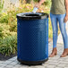 A large blue round outdoor trash can with a flat black lid, designed for heavy-duty use.