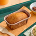 A small rectangular vegan banana pound cake in a brown paper baking tray.