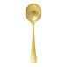A gold-colored stainless steel soup spoon with a vintage finish.