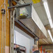 An industrial air curtain unit installed above a doorway in a commercial or warehouse setting.