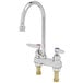 A chrome T&S deck mount medical faucet with two gooseneck faucets and red and blue knobs.