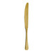 A gold-colored stainless steel dinner knife with a simple, classic design.