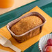 A small rectangular gingerbread pound cake in a brown paper baking tray.