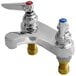 A T&S chrome deck mount faucet with two handles.