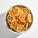 A bowl filled with dried orange slices.