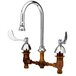 A chrome T&S deck mount faucet with gooseneck spout and wrist action handles.