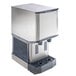A stainless steel countertop nugget ice machine and water dispenser with hands-free dispensing.