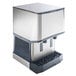 A stainless steel countertop nugget ice machine and water dispenser with hands-free dispensing.