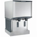 A stainless steel wall-mount air-cooled nugget ice machine and water dispenser with hands-free dispensing.